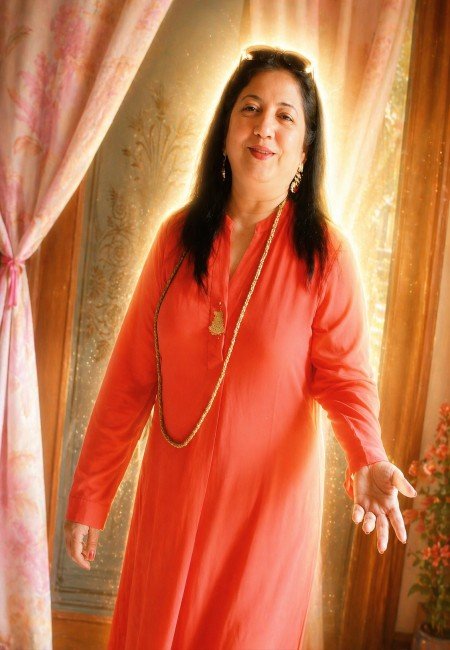 Woman in soft golden light with a subtle aura, representing calm presence and inner strength